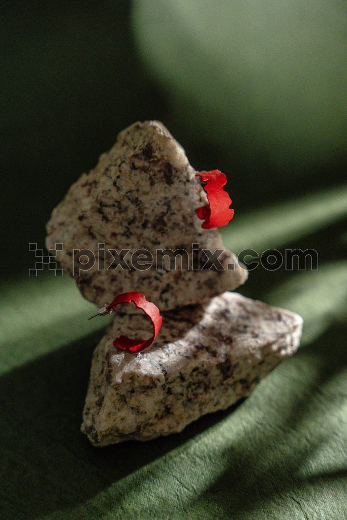 Red ear ring on stone image.