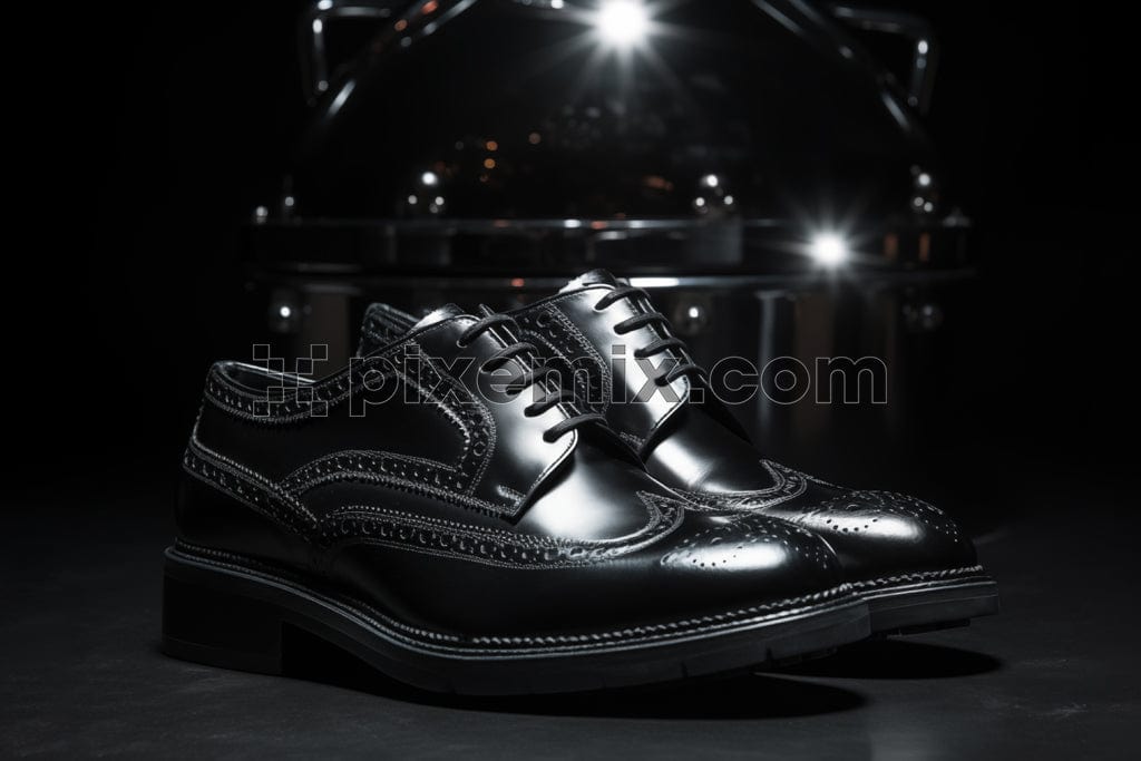 Male black leather shoes on black background image.