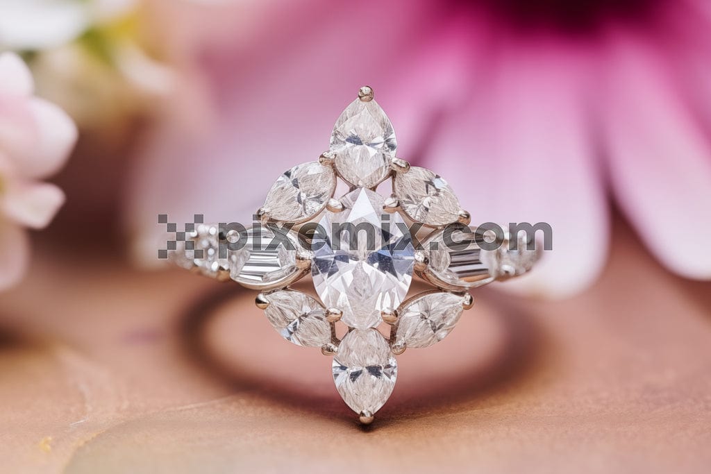 A sparkling diamond ring rests against a backdrop of soft pink petals image.