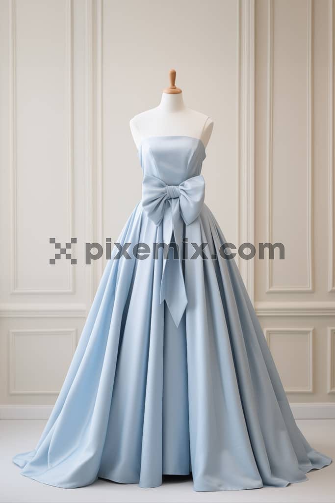 A fashionable powder blue gown displayed on a premuim mannequin against an aesthetic backdrop image.