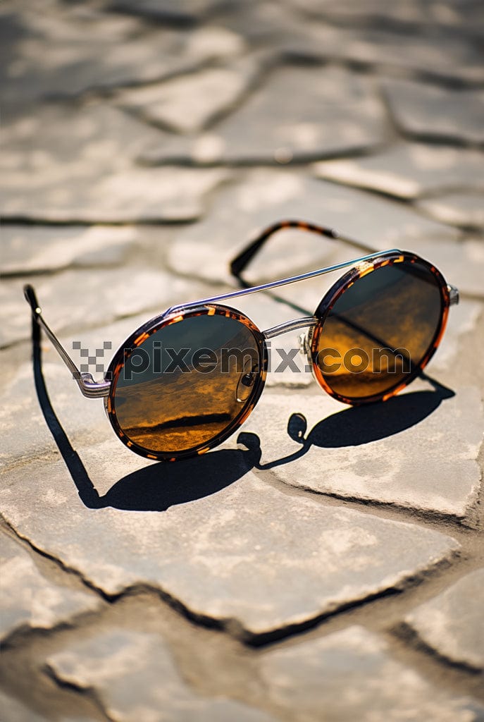 A classic brown pair of sunglasses on a textured base image.
