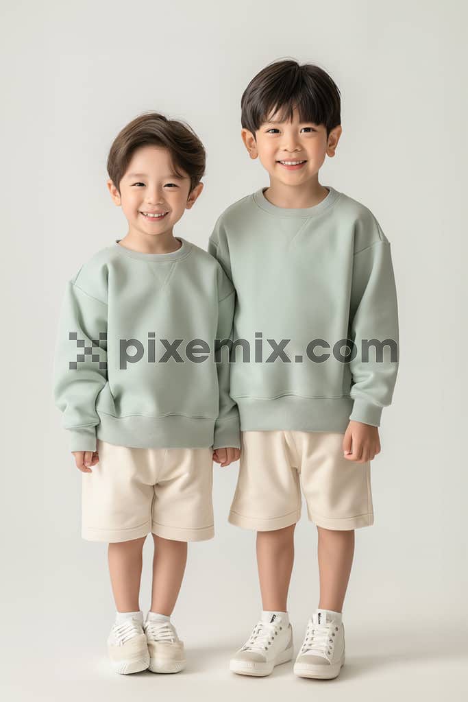 An image of two kids posing for a fashion magazine shoot.