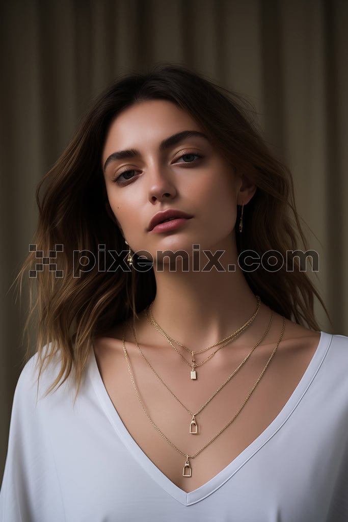 Portrait Of young female with stylish hairstyle wearing white top with makeup In gold  Jewelry image. 