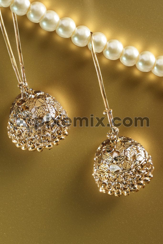 Earrings on round pearl necklaces image.
