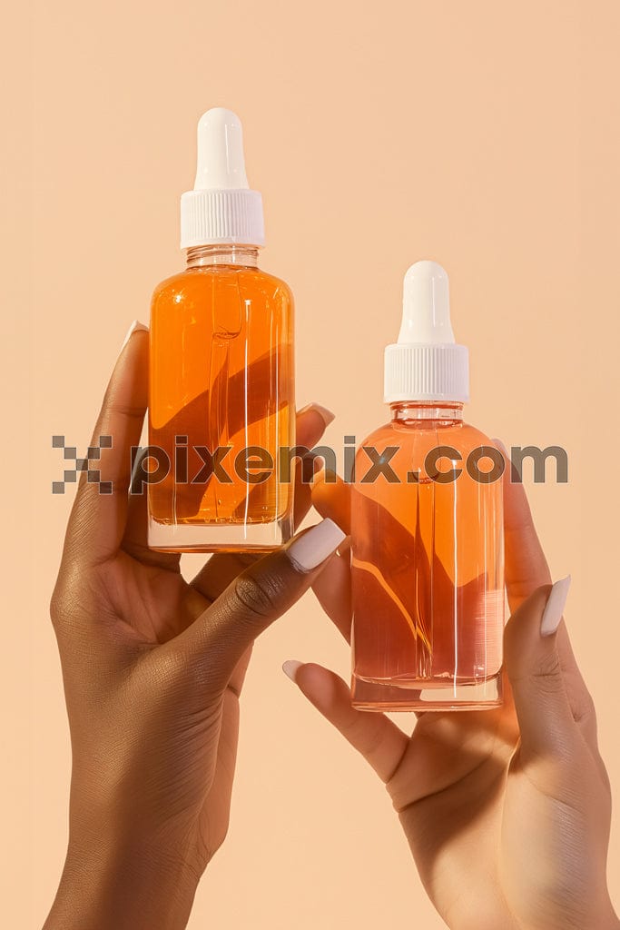 Two woman hands holding glass serum bottle on beige background image.