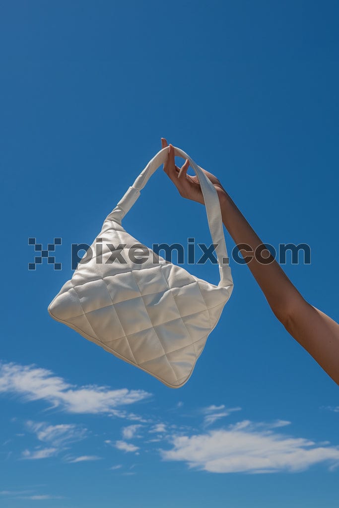 Luxury white leather bag in croped woman handbag on blue sky background image.