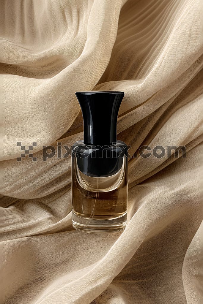 Perfume bottle on beige fabric background image.