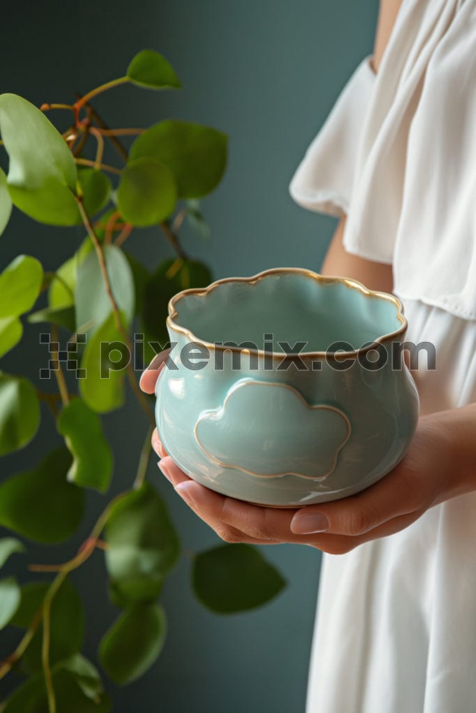 Hand holding an empty ceramic pot image. 