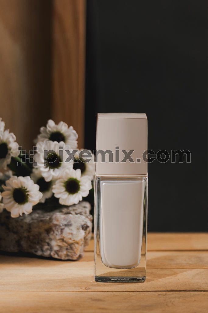Cosmetics liquid foundation cream bottle on wooden table image.