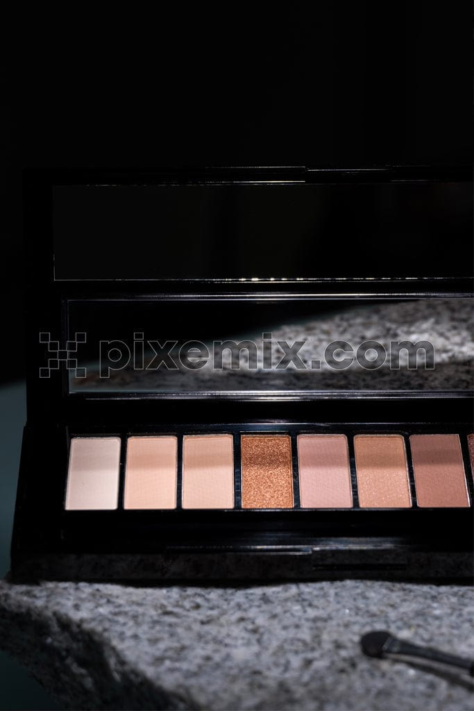 Closeup of makeup palette on stone image.