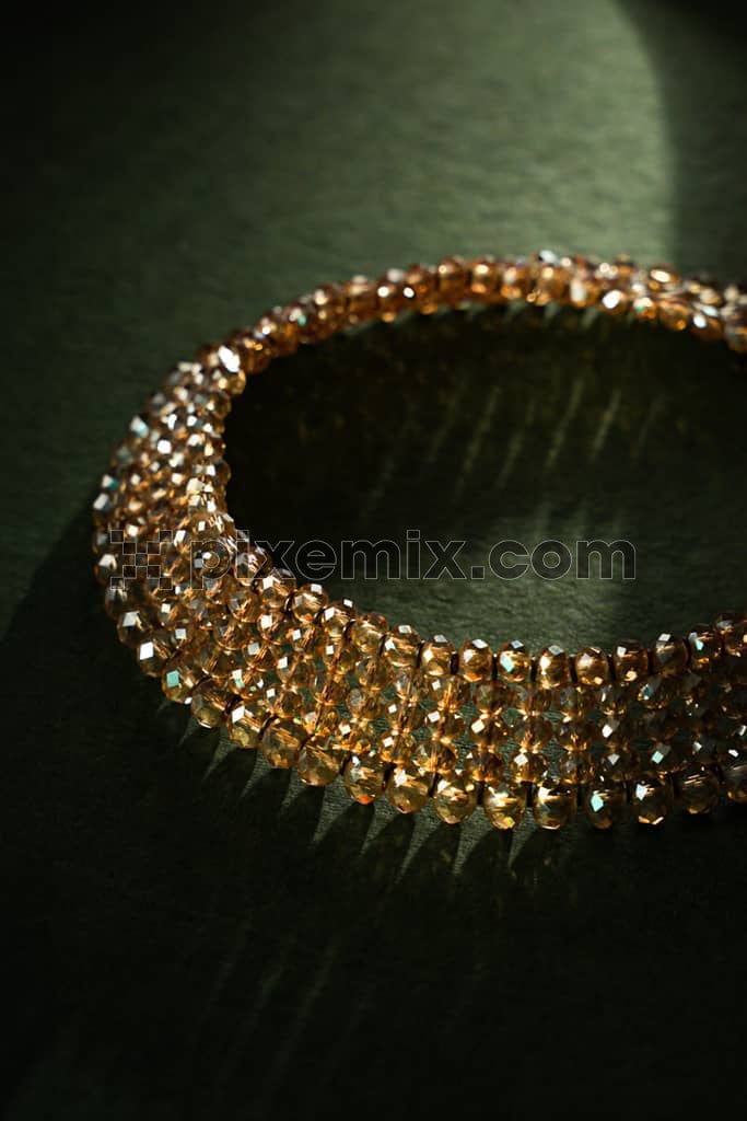 Luxury traditional gold necklace on green background image.