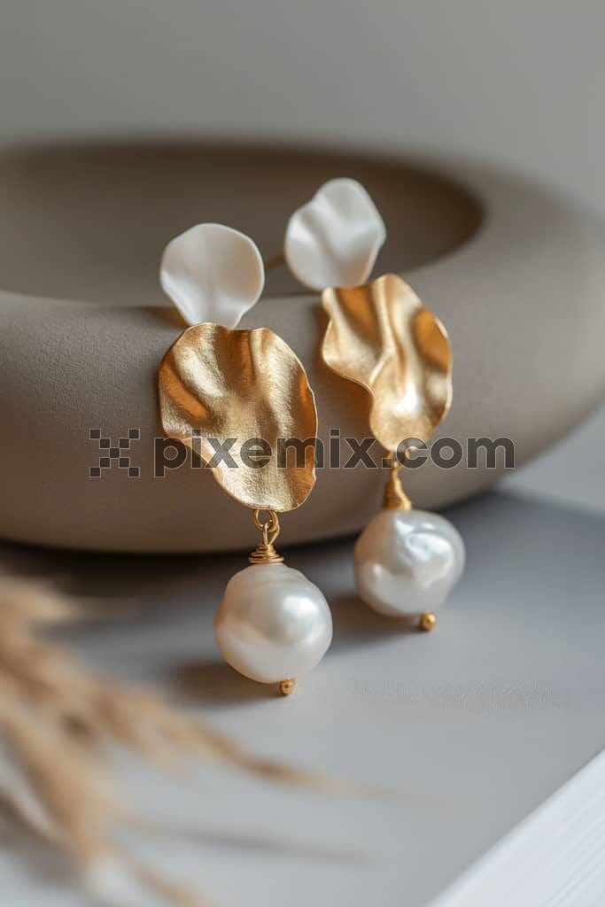 Pair of pearls gold earrings image.