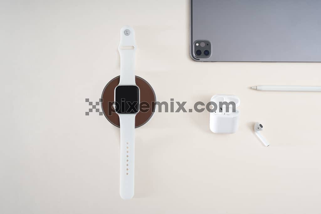 Ipad and digital watch on beige background image.