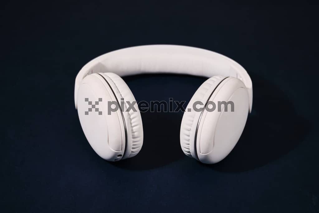White headphone on blue background image.