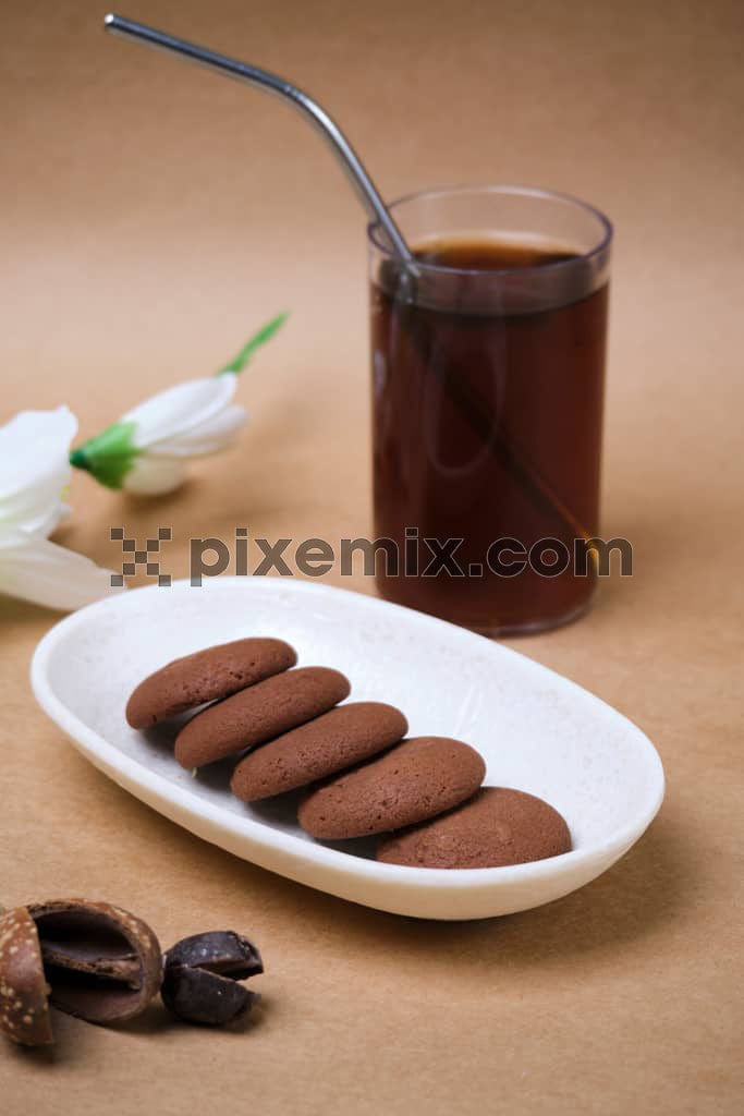 Plate of freshly baked chocolate cookies with black coffee image.