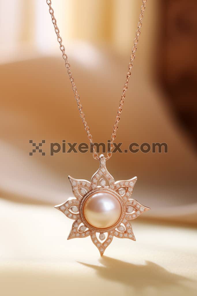 Image of beautiful rose gold pendant with pearl and a blurred background.