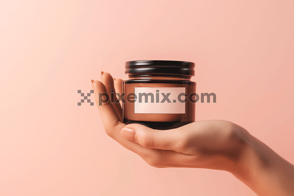 Skincare shoot-inspired hand-holding cosmetic jar on peach background stock image.