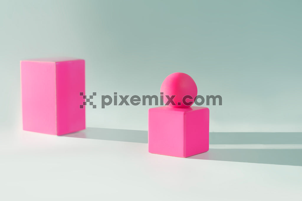 Minimalist composition with pink geometric shapes casting long shadows on a pastel green background.