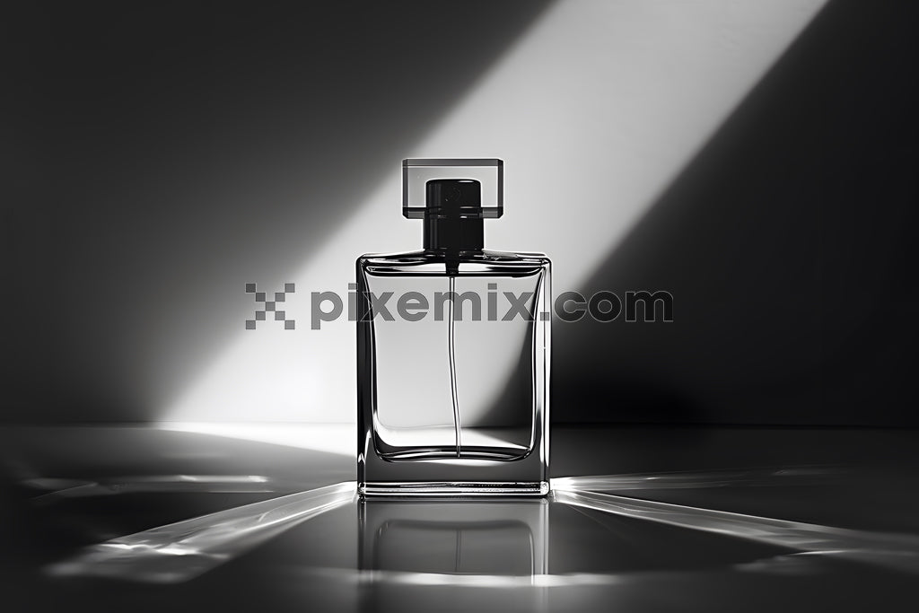 Elegant glass perfume bottle in spotlight with dramatic shadows on a black and white background.