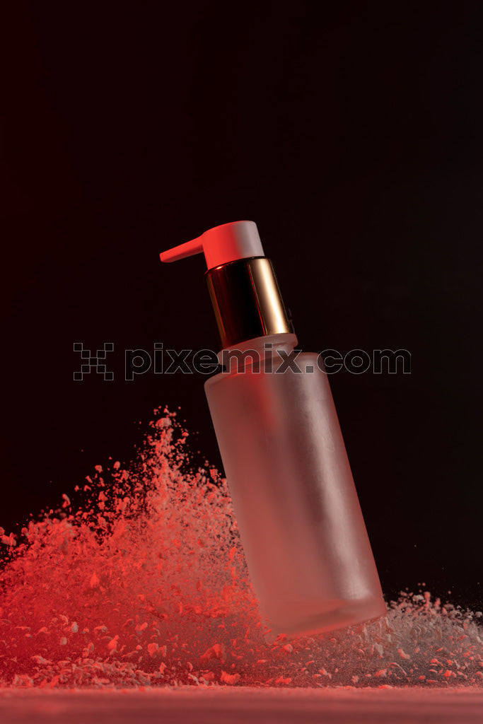 Elegant skincare product bottle with red lighting and powder splash against black background.