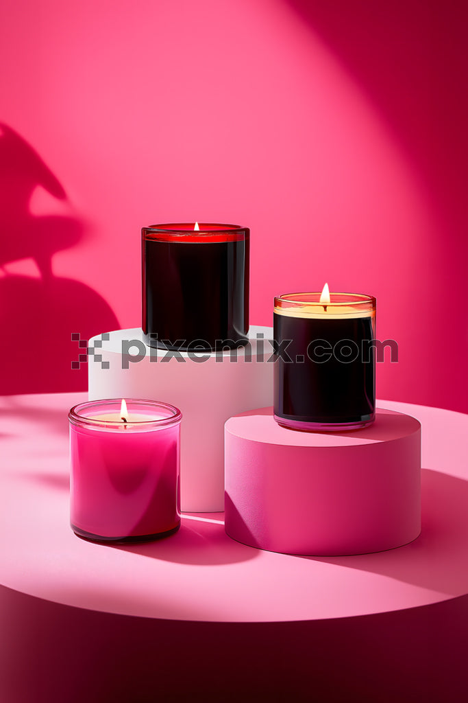 
Elegant burning candles in glass jars on pink pedestal display with vibrant modern background.