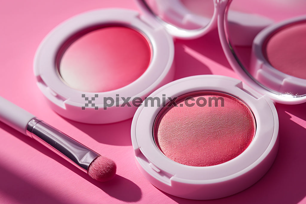 Close-up of pink blush compacts and brush on a vibrant pink background under natural light.