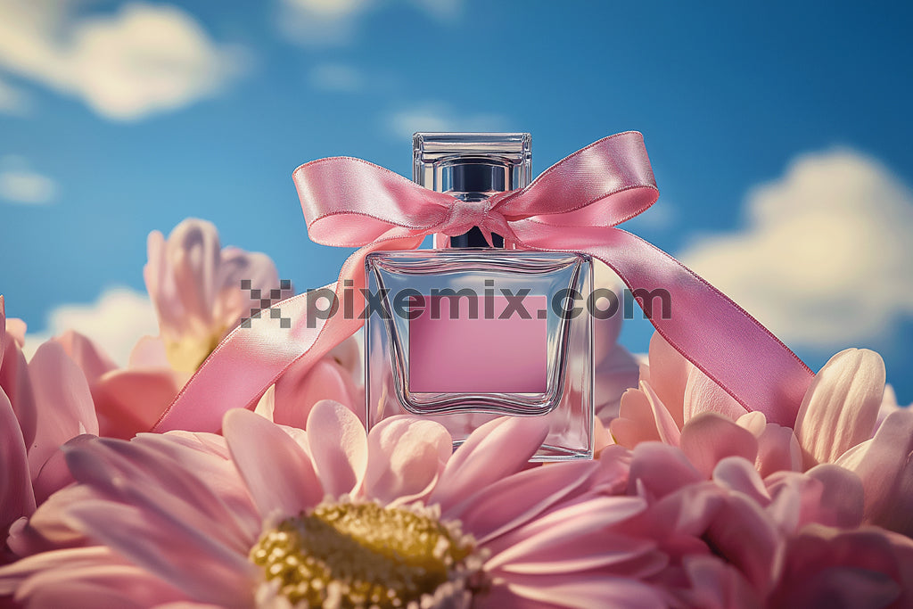 Romantic pink perfume bottle with ribbon among flowers stock image.