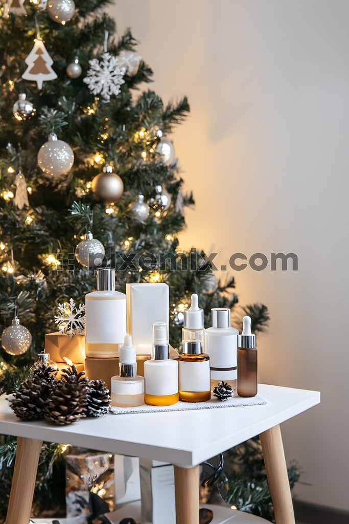 Luxury skincare gift set on table in front of Christmas tree with festive vibes stock image.