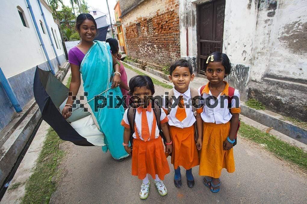 Unidentified Happy Indian rural school students going to school with parent image
