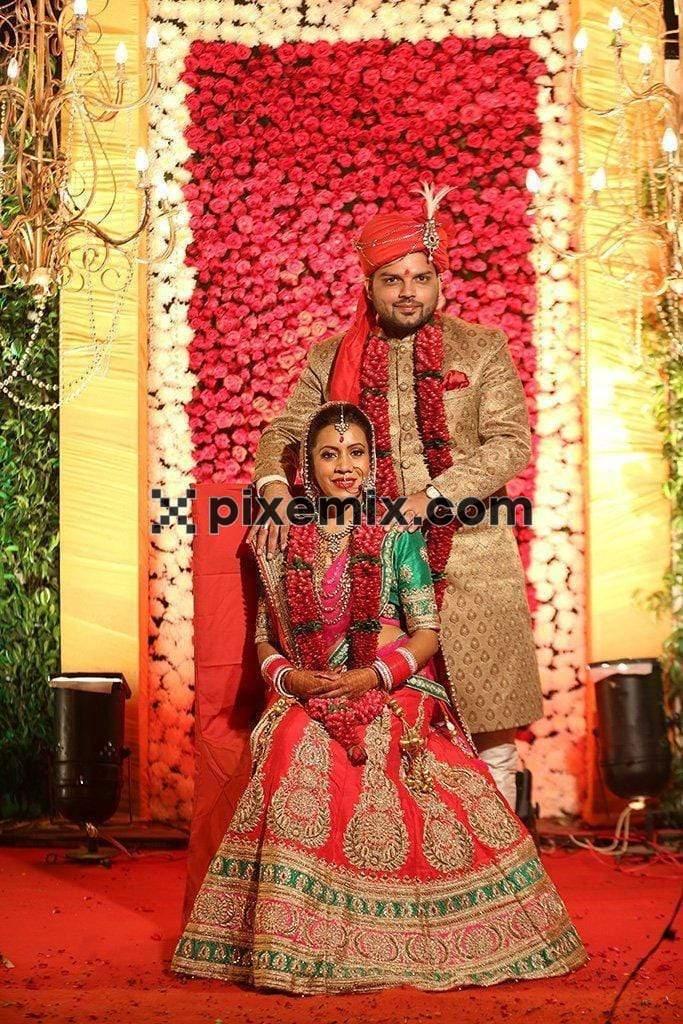 Indian bride and groom posing for photoshoot image