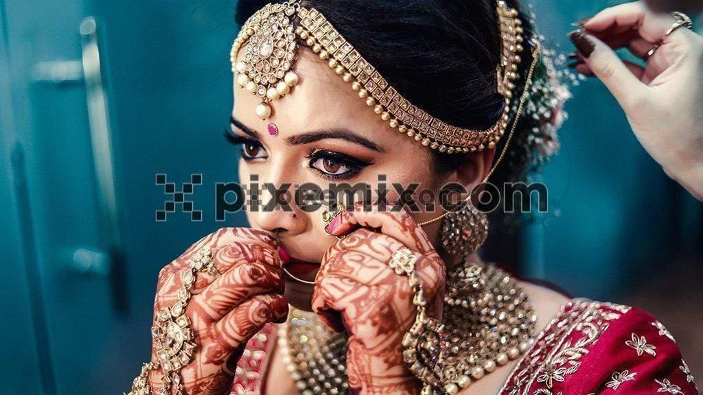 Indian bride putting her nose ring image