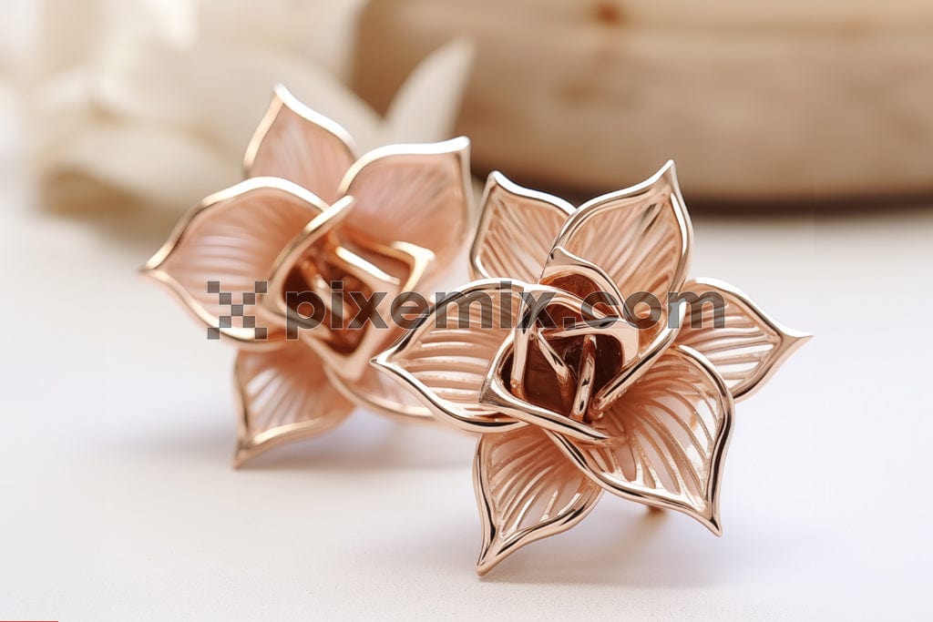 A pair of elegant rose gold earrings in the shape of delicate flowers image.