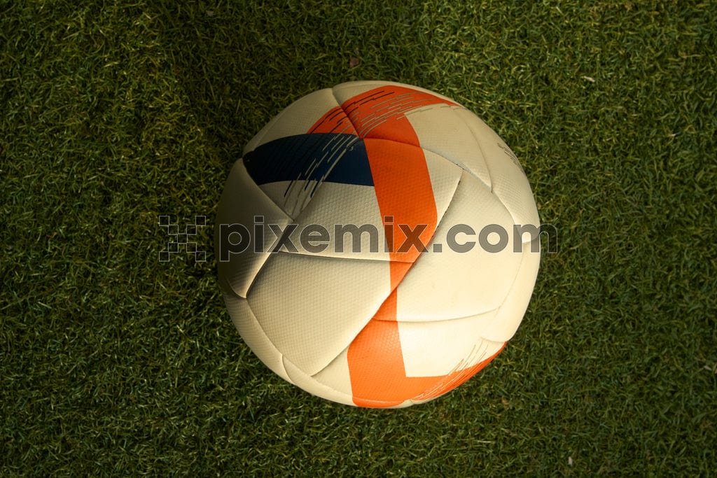 Classic soccer ball/football sits on a vibrant green field image.